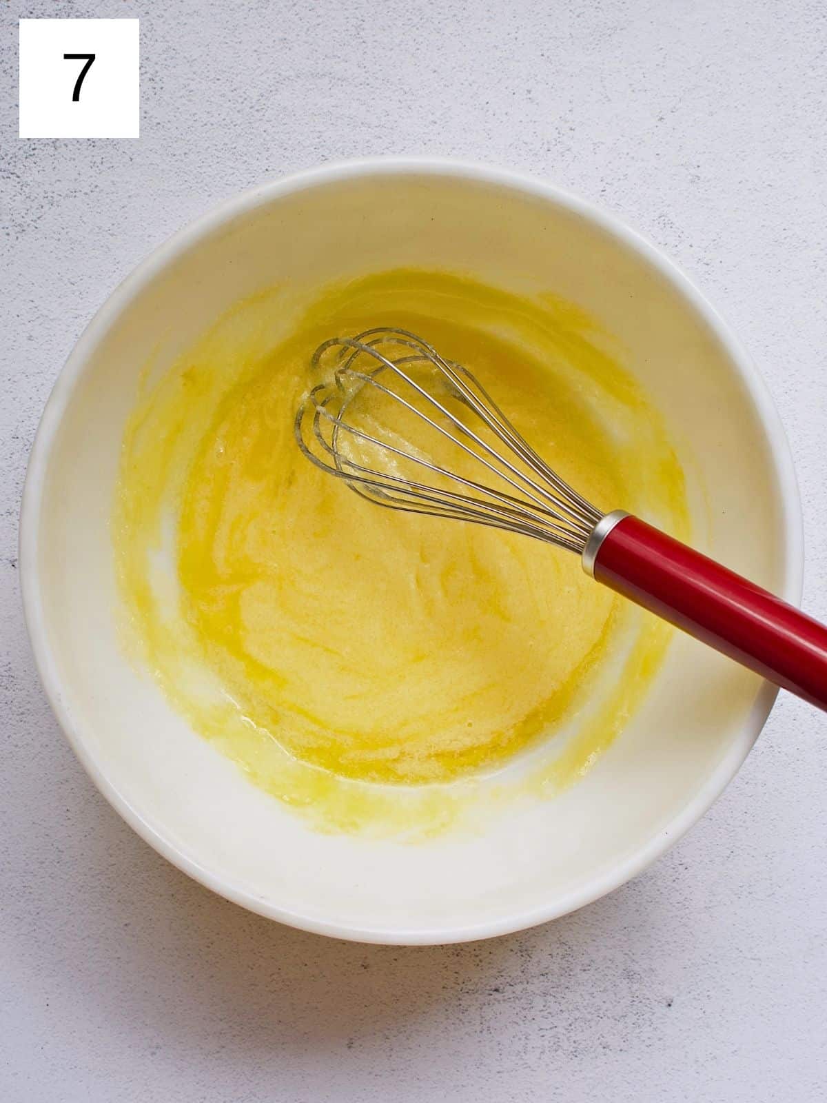 Whisked melted butter, sugar, and egg in a bowl.