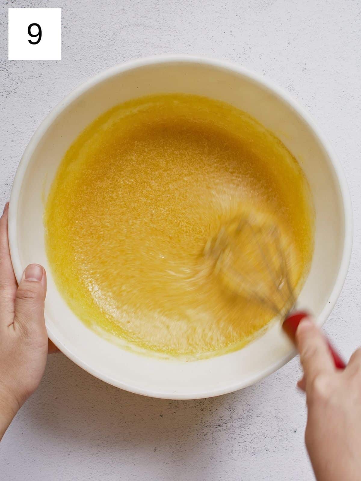 A person whisking mango mixture.