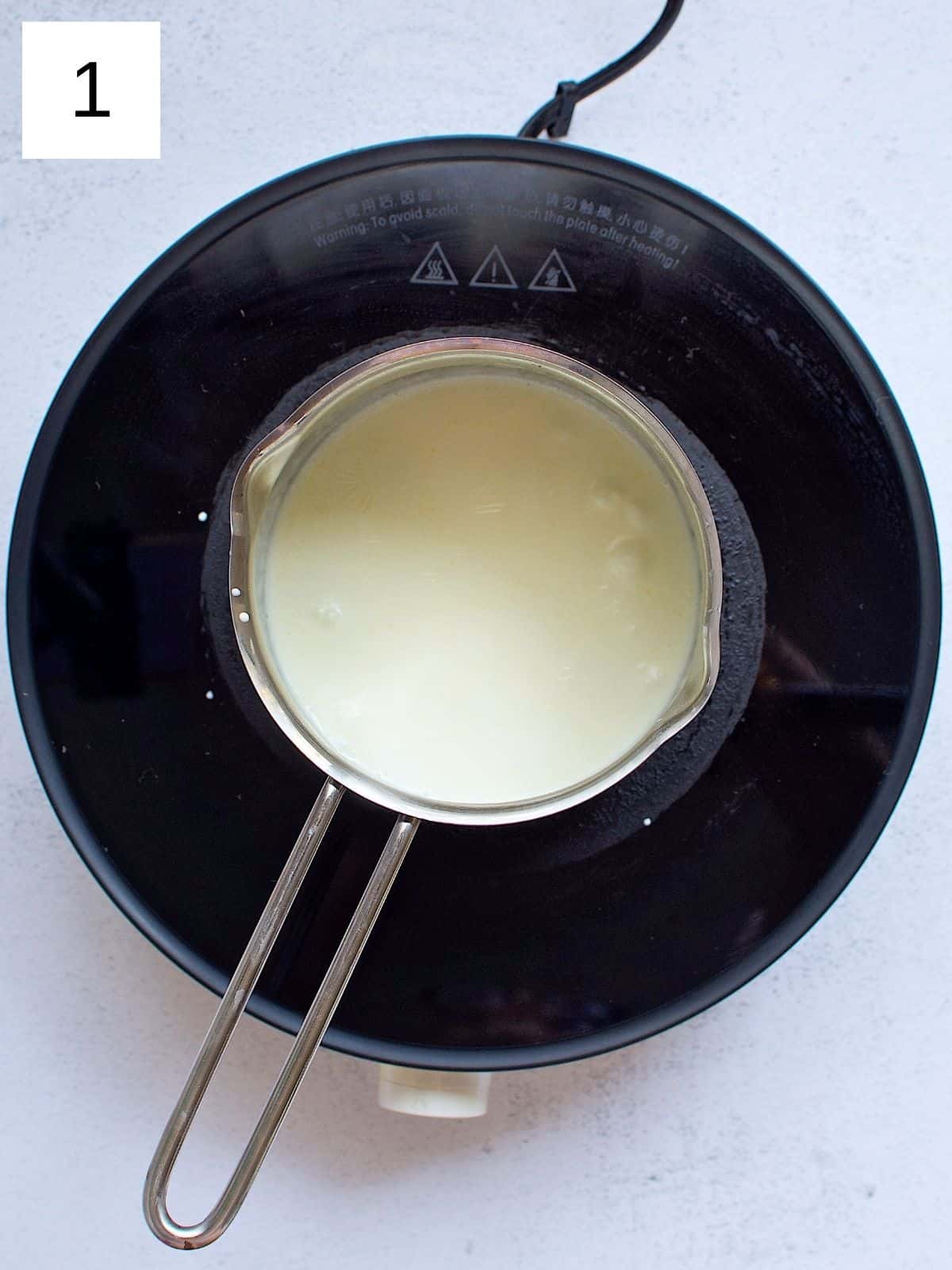 A pan of heavy cream being heated.