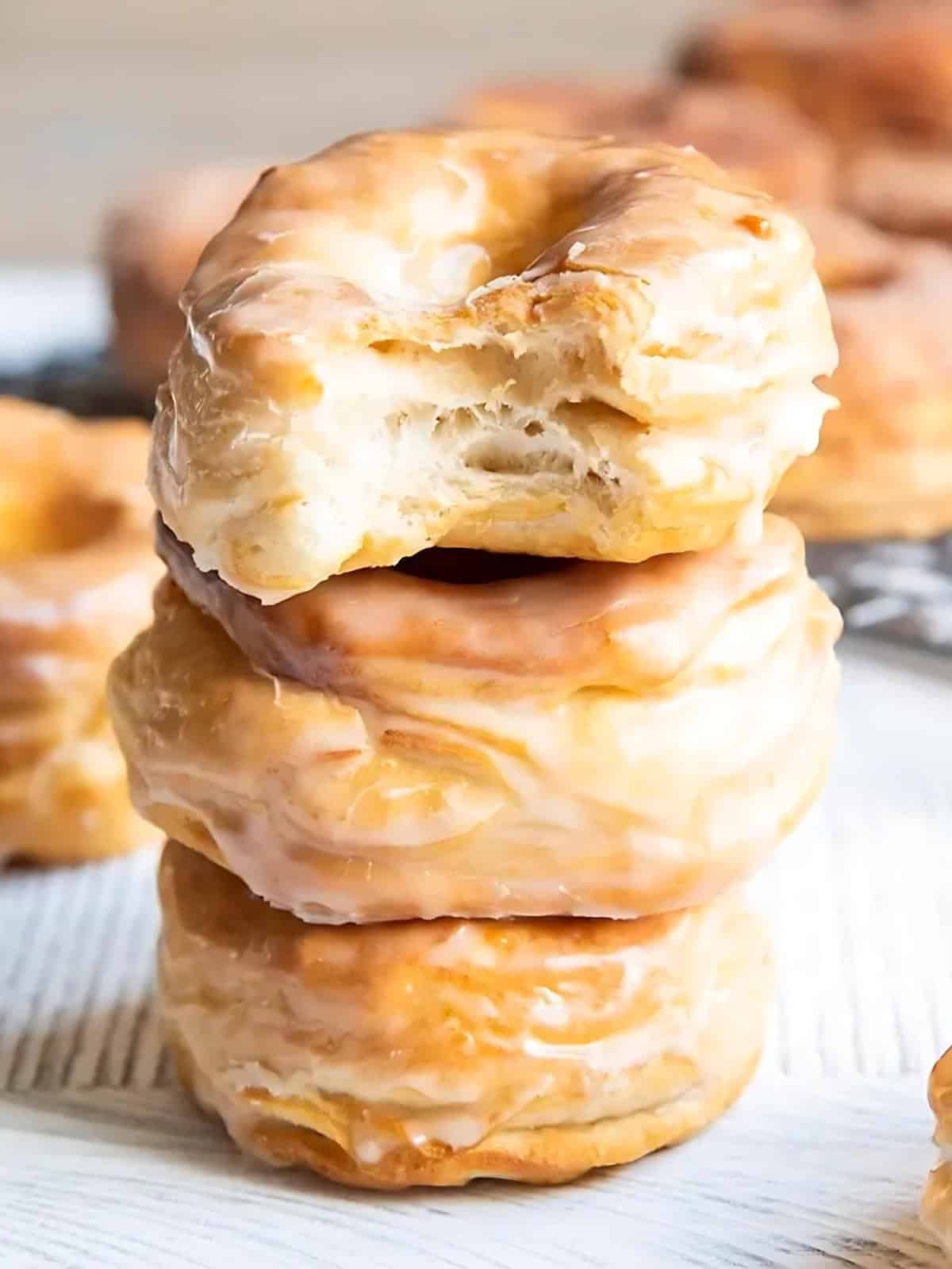 Stacked glazed biscuit donuts.