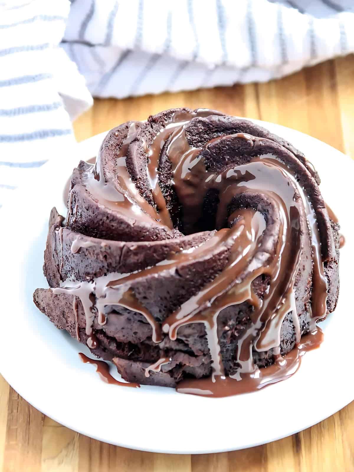 Chocolate bundt cake drizzled with melted chocolate.