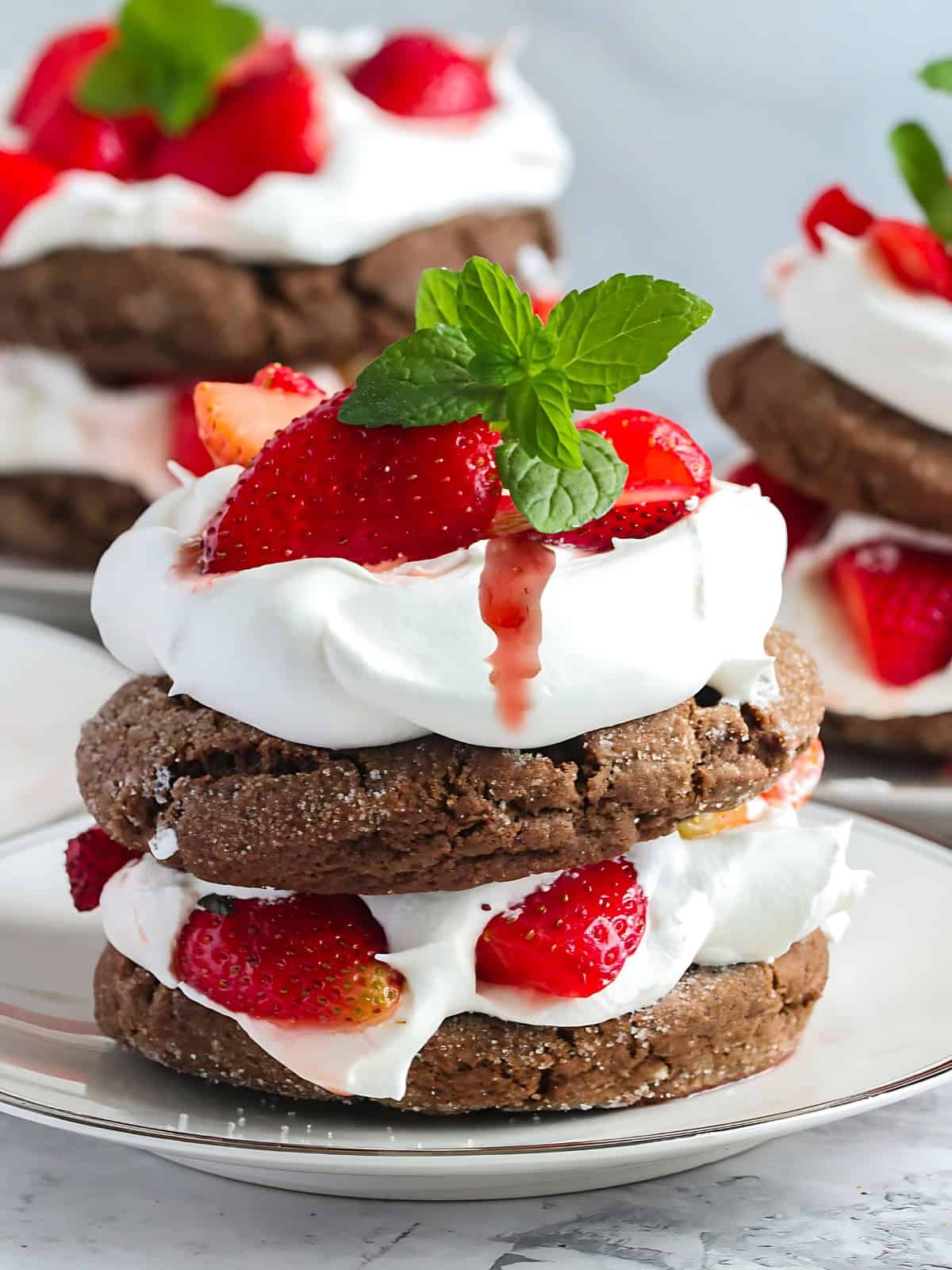 Chocolate strawberry shortcake topped with whipped cream and strawberries.