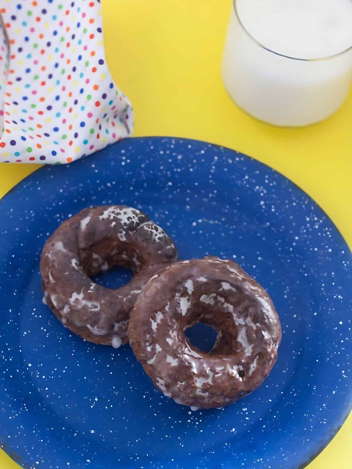 Low fat chocolate donut covered with sugar cream on a plate.
