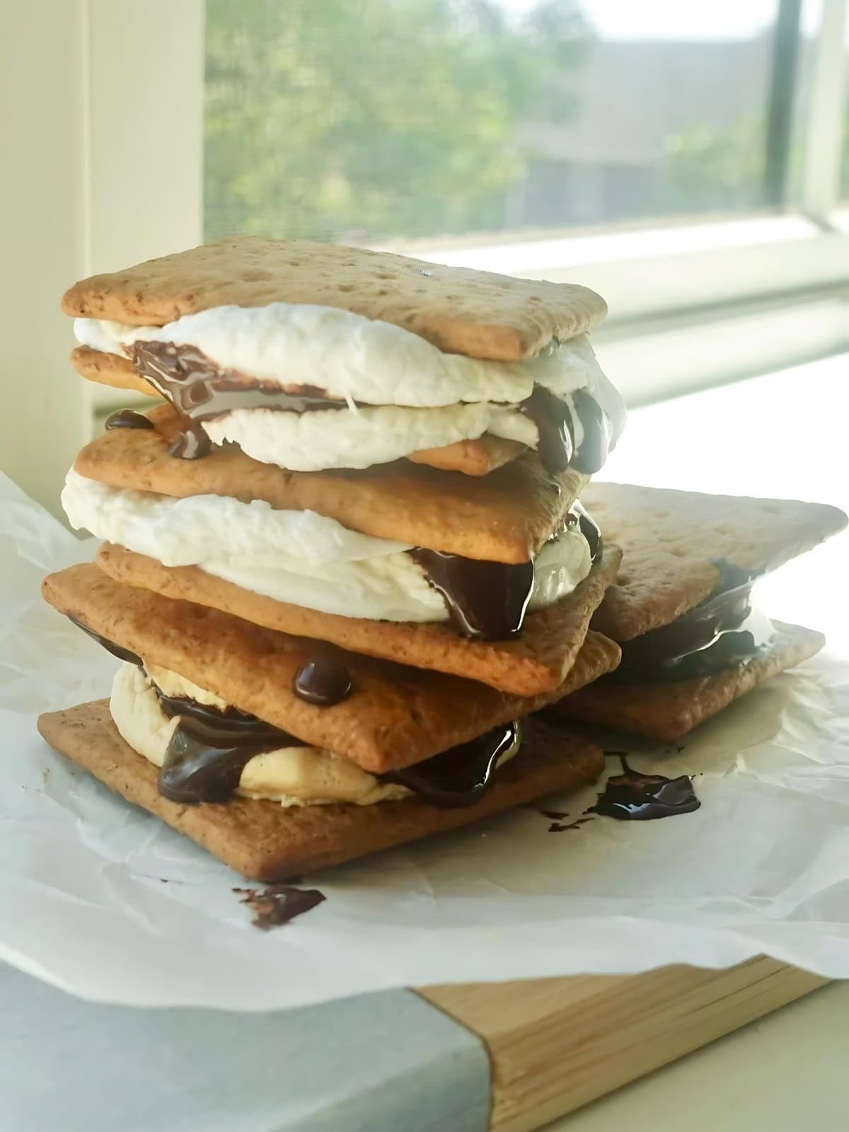 A stack of smores drizzled with melted chocolate.