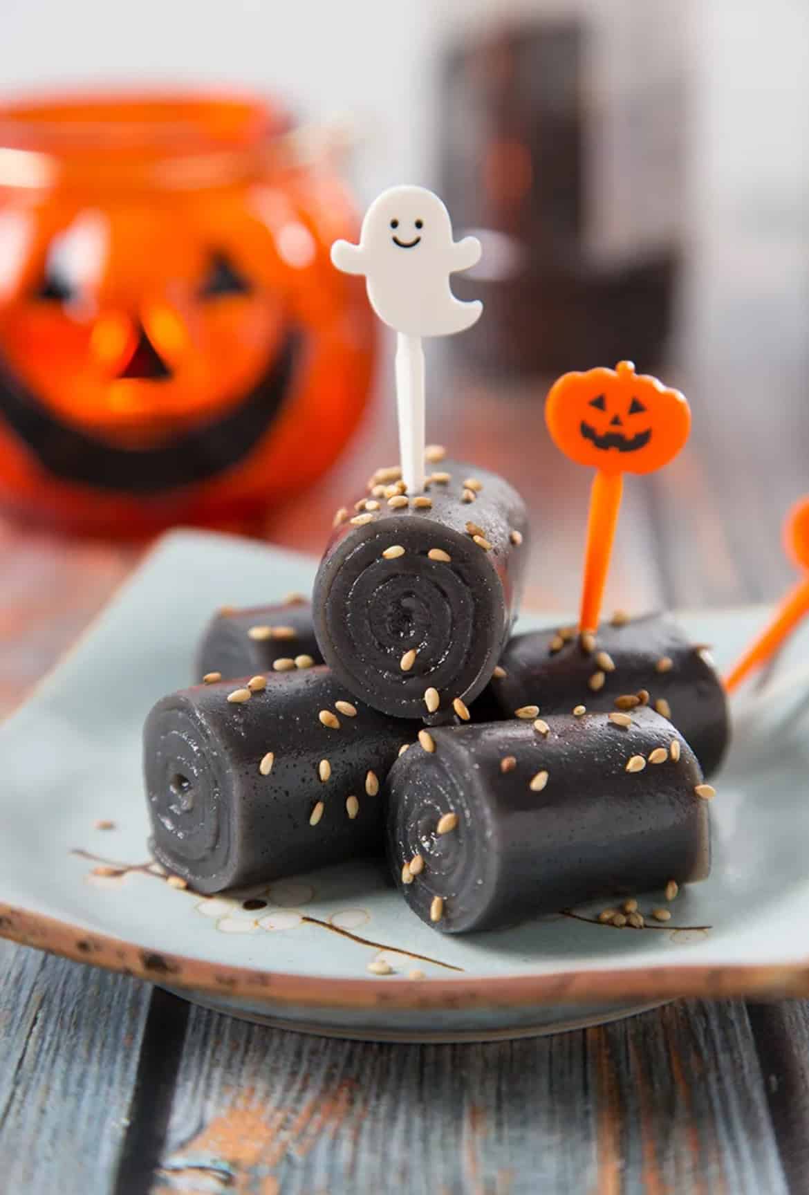 Halloween themed black sesame rolls sprinkled with sesame seeds.