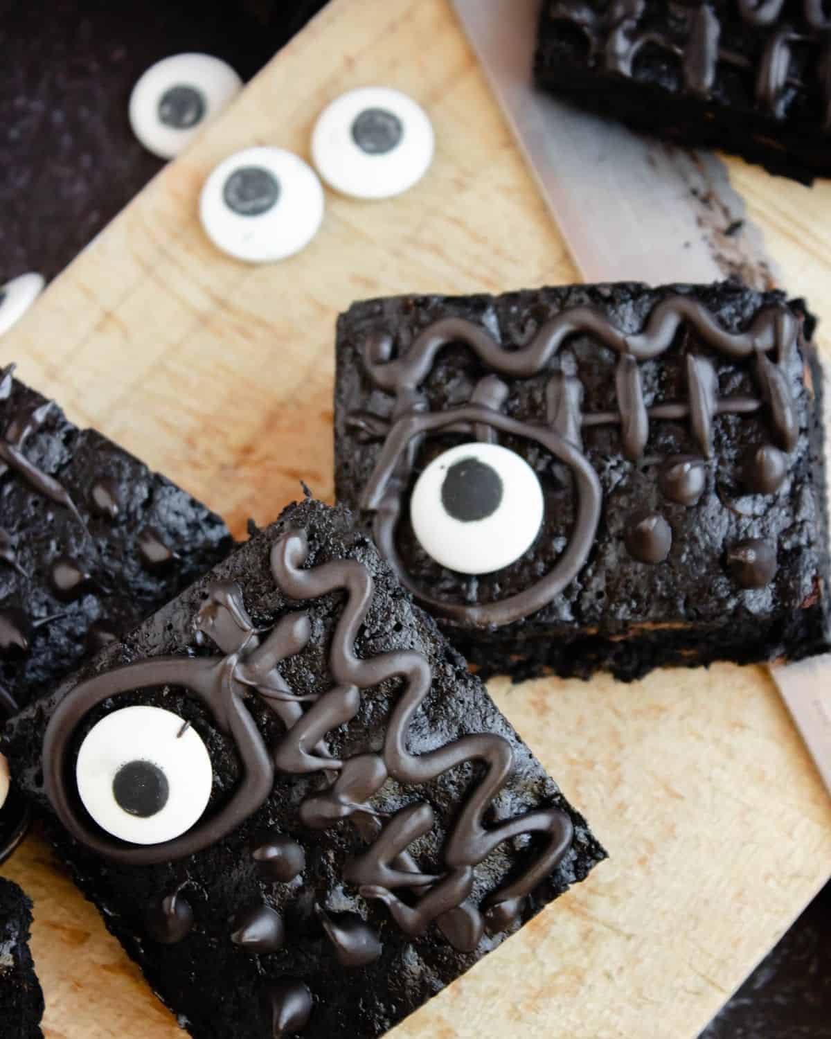 Halloween themed hocus pocus brownies on a wooden board.