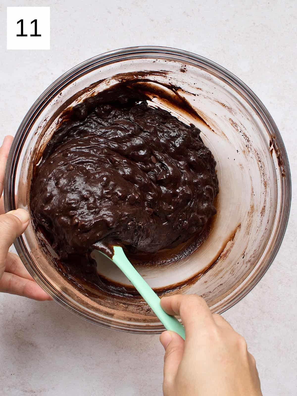 step 11 of making brownie cookies, featuring the cookie batter mixed with chocolate chips.