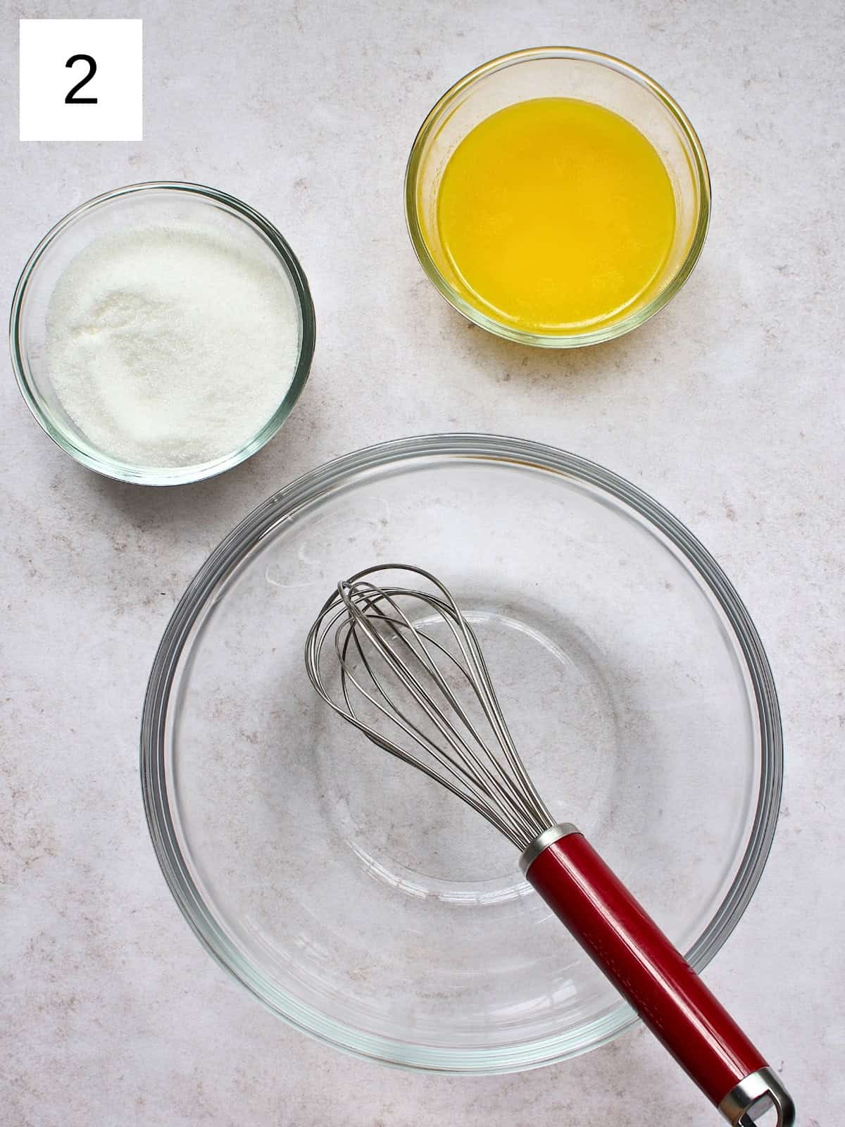 step 2 of making brownie cookies, showing sugar and melted butter in a separate bowl, ready to be mixed.