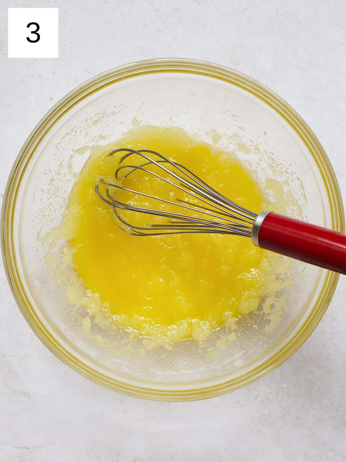 step 3 of making brownie cookies, showing a mixture of sugar and melted butter.