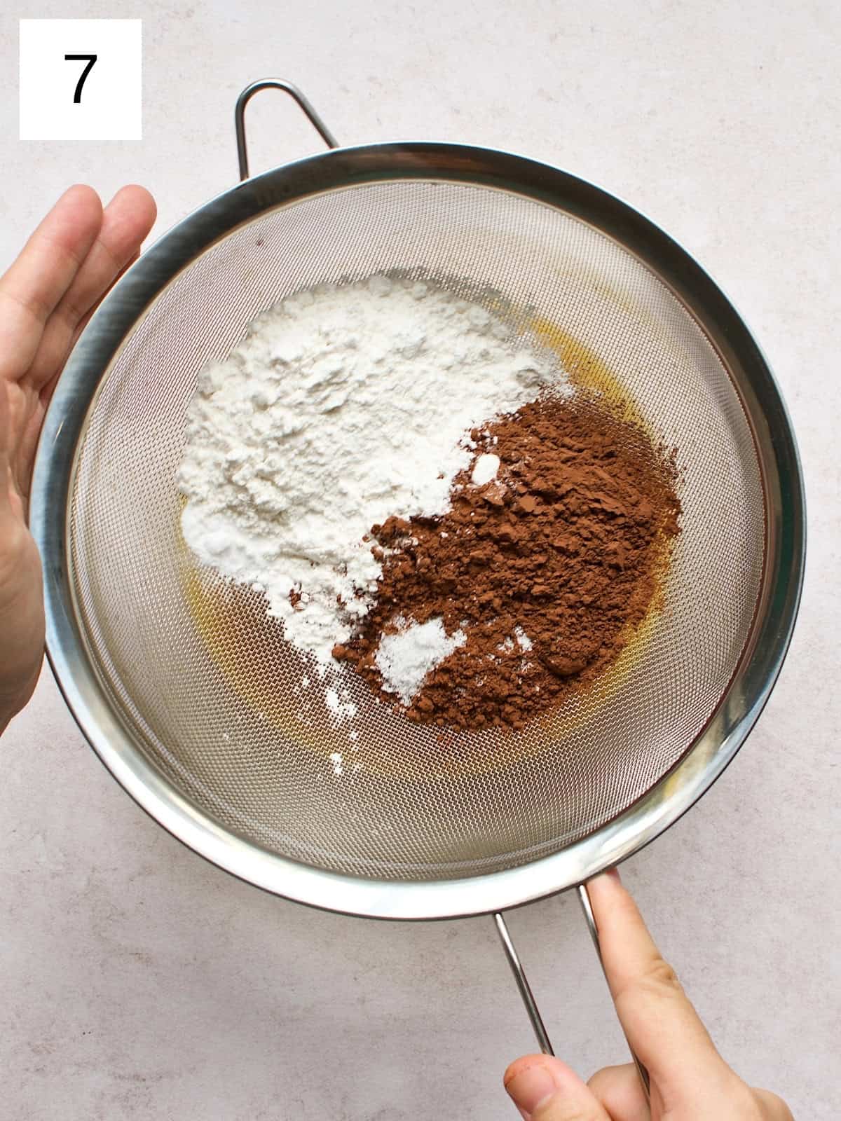 step 7 of preparing brownie cookies, showing the dry ingredients being mixed into the wet ingredient mixture.