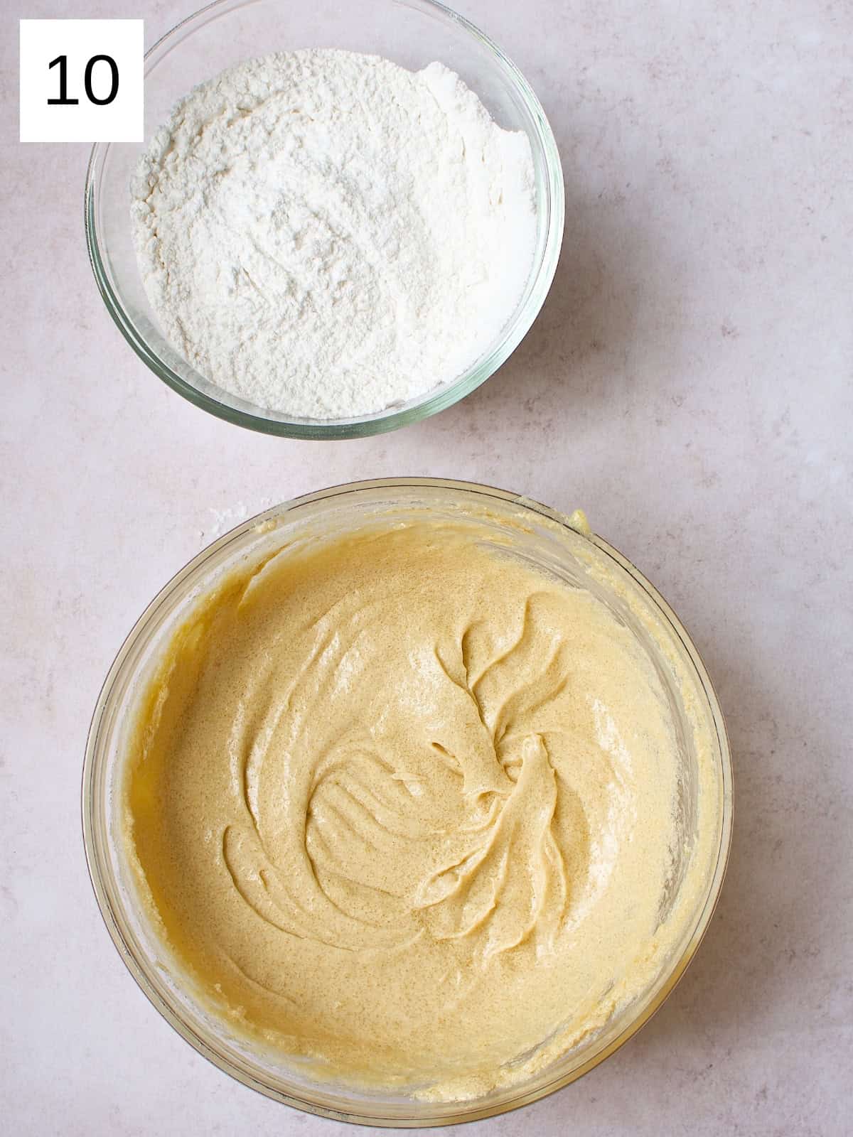 Two bowls, one filled with a mixture of butter and one filled with a mixture of dry ingredients of flour, baking soda, and salt.