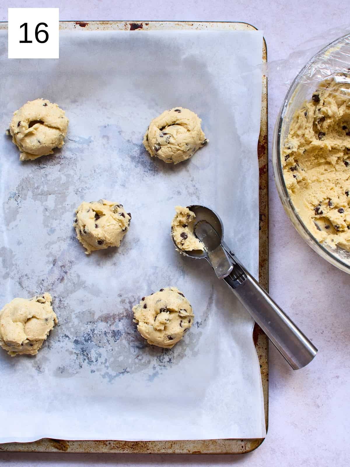 Perfectly scooped cookie batter on a baking tray, ready to be baked into delicious, golden cookies.