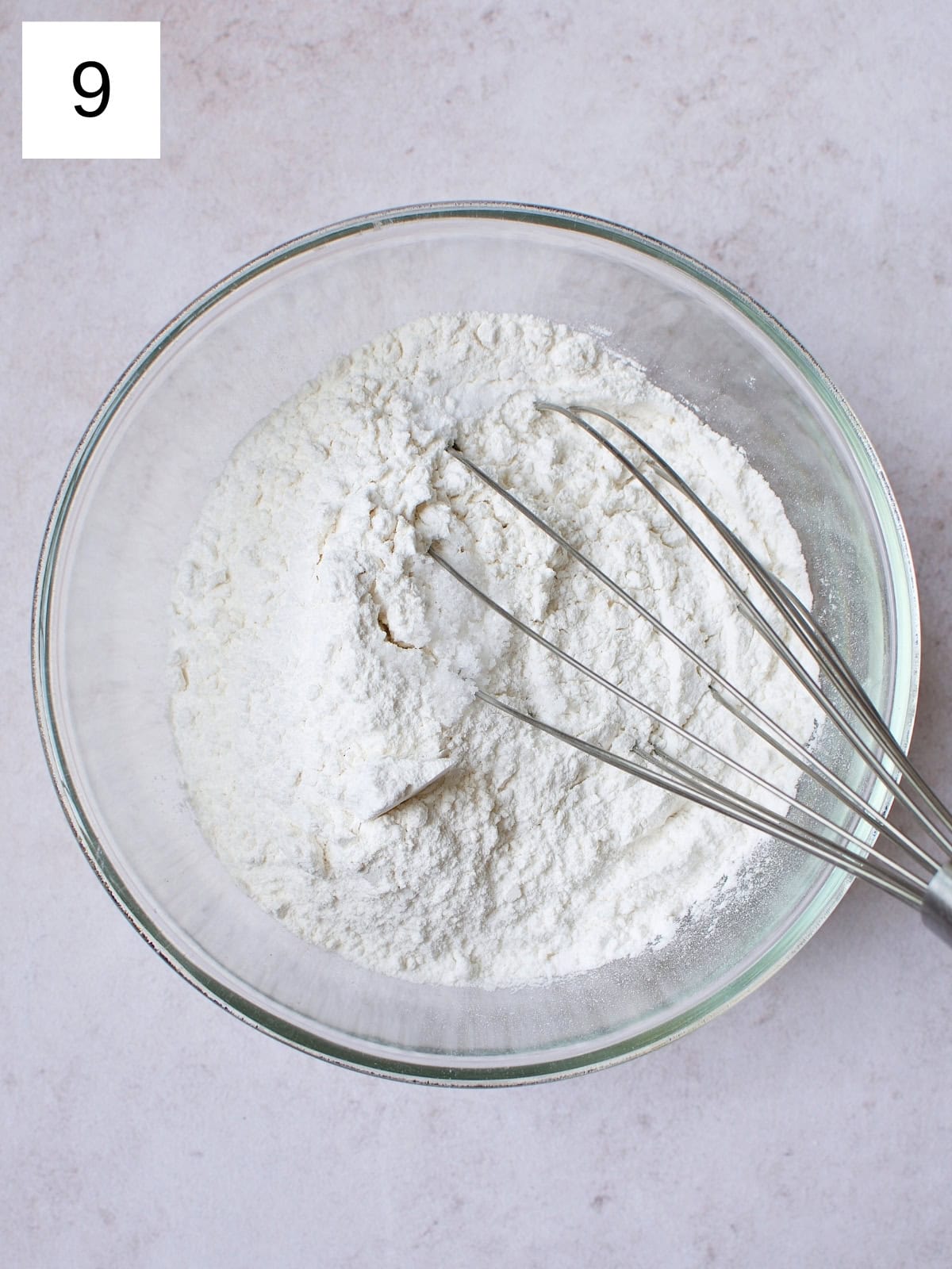 A bowl containing a blend of all-purpose flour, baking soda, and salt.