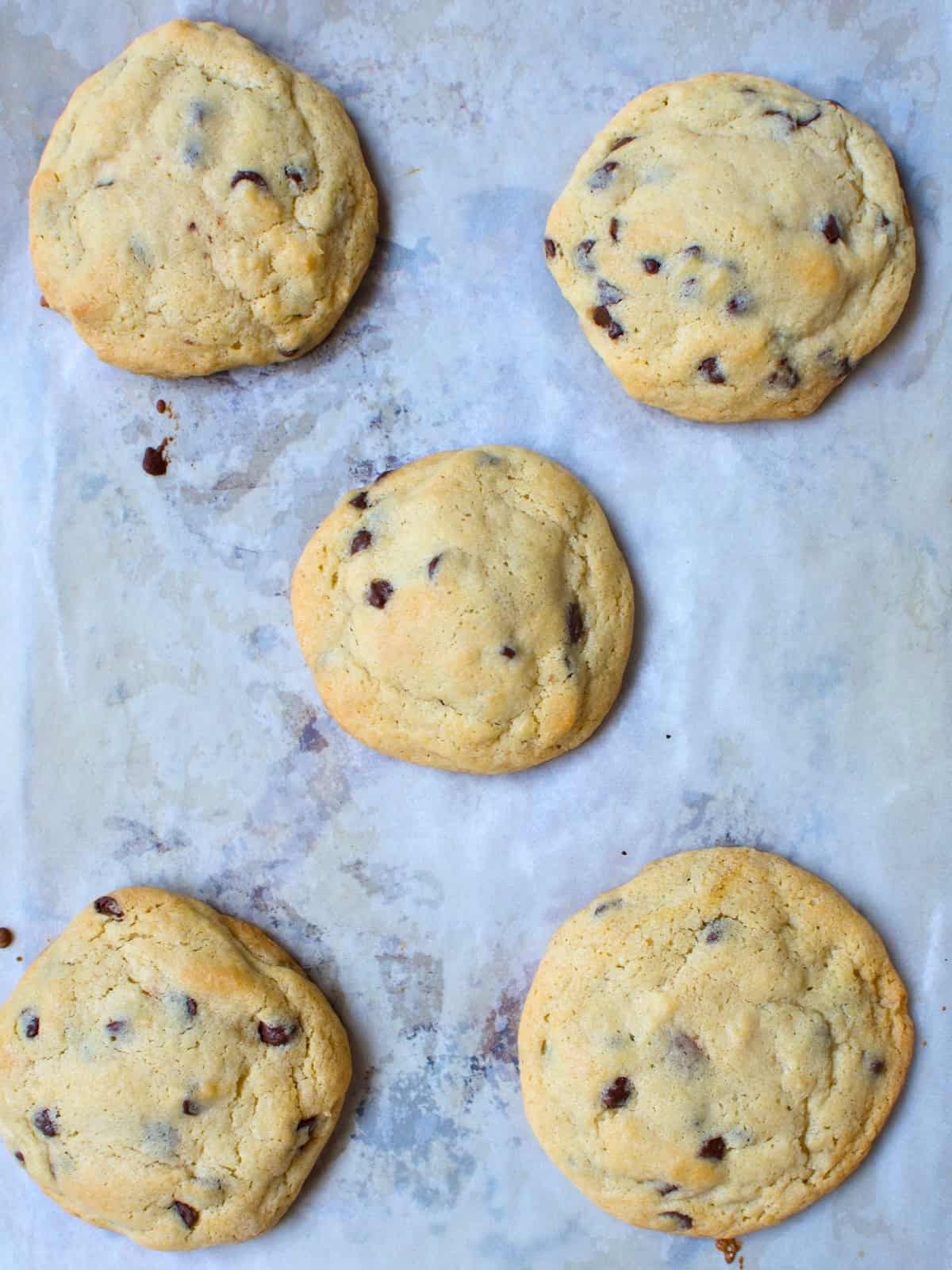 Freshly baked chocolate-filled cookies in a baking tray.