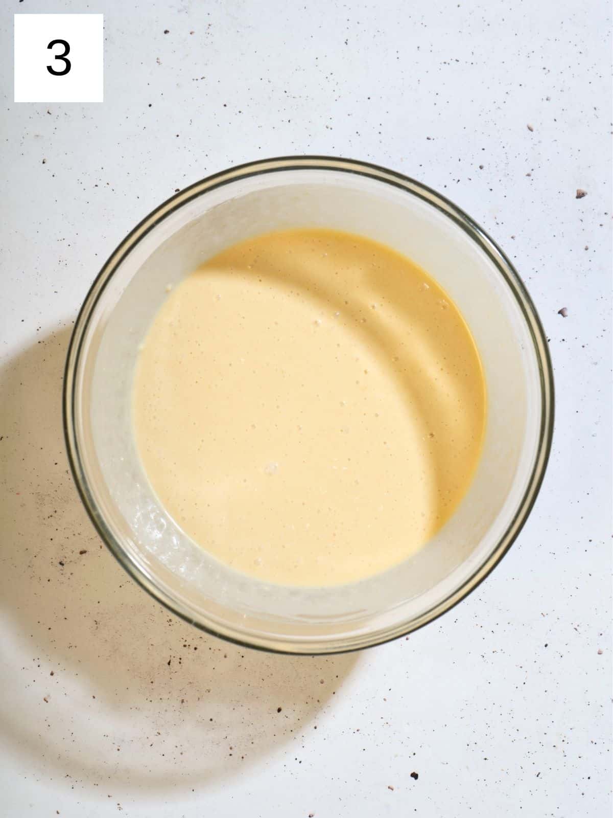 A bowl filled with mixture of pancake batter.