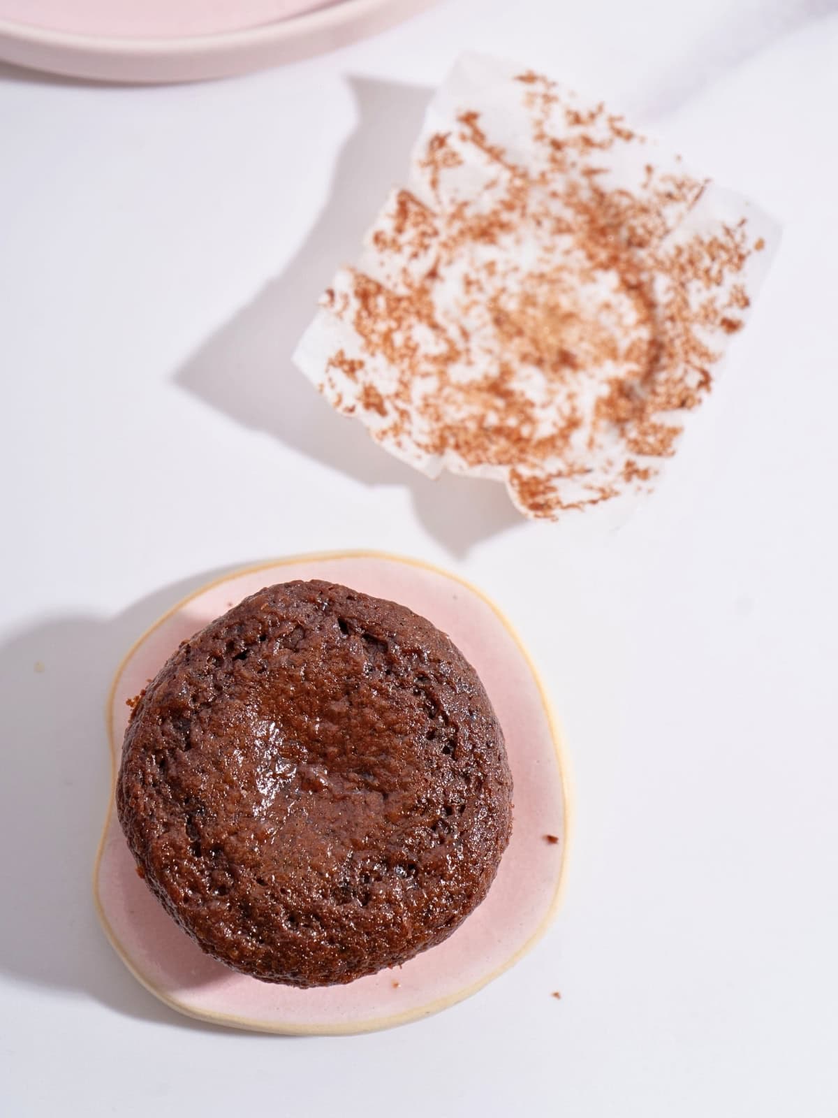 A freshly baked moist chocolate cupcake with a soft, tender crumb and rich chocolate color.
